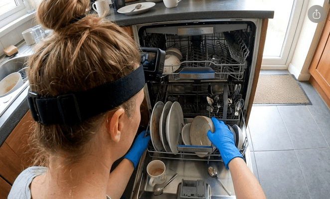 Contributor loading dishwasher with head-mounted phone camera